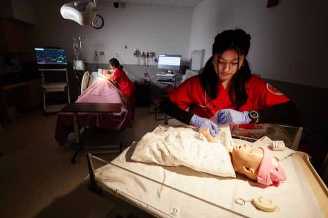 A nursing student practicing specialized care
